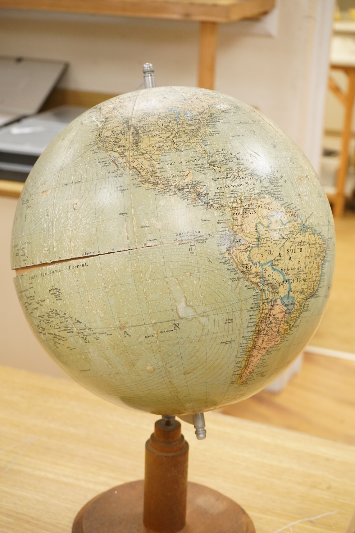 A mid 20th century 12 inch terrestrial globe on an oak base with integrated compass, the globe printed with; ‘Printed in Germany’, overall height 55cm